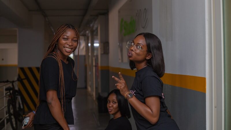 Black students smiling together in a hallway
